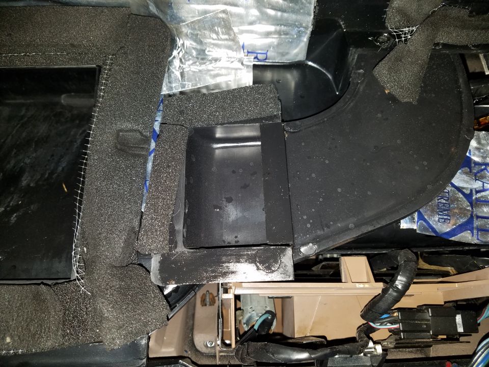Car interior showing foam insulation and black ductwork, possibly HVAC related