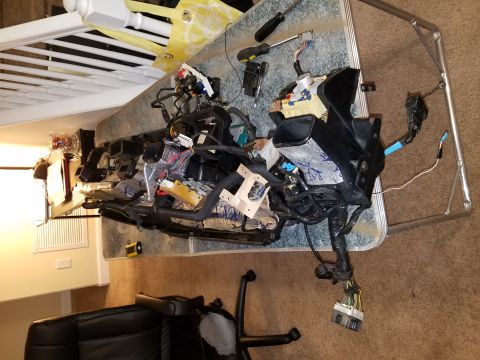 1994 Ford Bronco - A complex automotive wiring harness, likely from a dashboard, is laid out on a table with tools nearby.