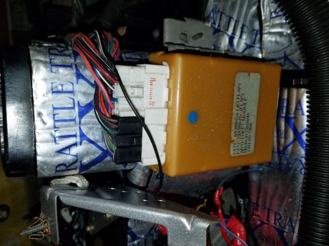 1994 Ford Bronco - Close-up of wiring harness connected to an anti-theft module, likely from a vehicle's interior.