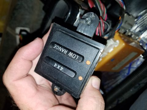 1994 Ford Bronco - Close-up of a 4x4 transfer case control switch with visible labels for 'LOW RANGE' and '4X4'.