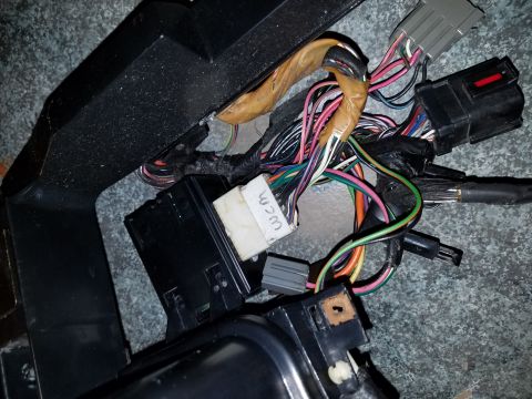 1994 Ford Bronco - A close-up view of a vehicle's dashboard wiring harness, with a label reading 'WCM' visible.