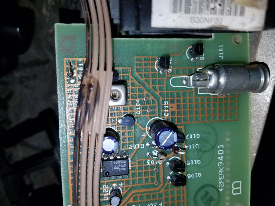 Close-up of a circuit board with wires and electronic components. Text on the board includes '2PEAK9401'