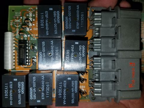 1994 Ford Bronco - Close-up of an electronic control module, likely from a vehicle's dashboard, several relays and connectors.