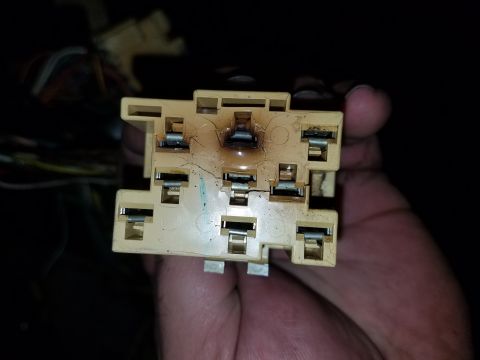 1994 Ford Bronco - Close-up of a damaged electrical relay socket, showing signs of overheating and melting.