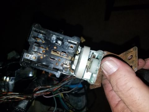 1994 Ford Bronco - A close-up view of a vehicle's headlight switch assembly, showing internal components and wiring.