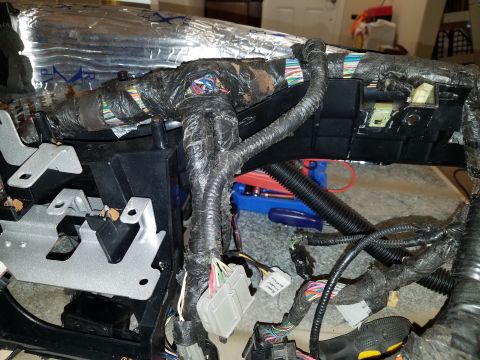 1994 Ford Bronco - A complex vehicle wiring harness is visible, with many wires bundled together and secured with black tape.