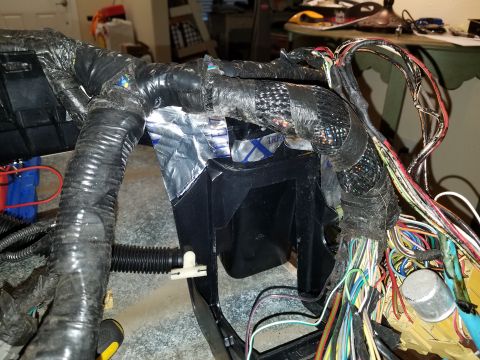 1994 Ford Bronco - A close-up view of a complex vehicle wiring harness, showing various wires and electrical components.