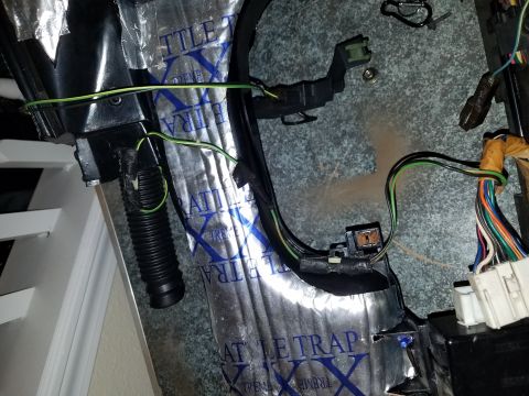 1994 Ford Bronco - Close-up view of a vehicle's interior wiring harness and sound deadening material.