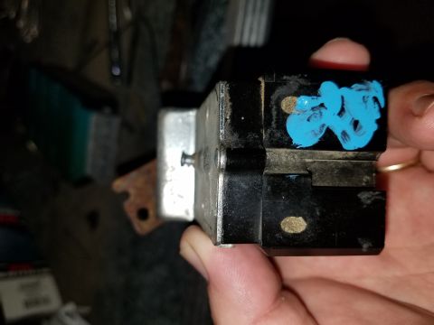 1994 Ford Bronco - A close-up of an automotive electrical component, possibly a relay or switch, marked with blue paint.