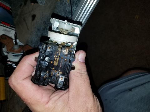 1994 Ford Bronco - An interior electrical switch assembly is held in a hand, showing its complex wiring and components.