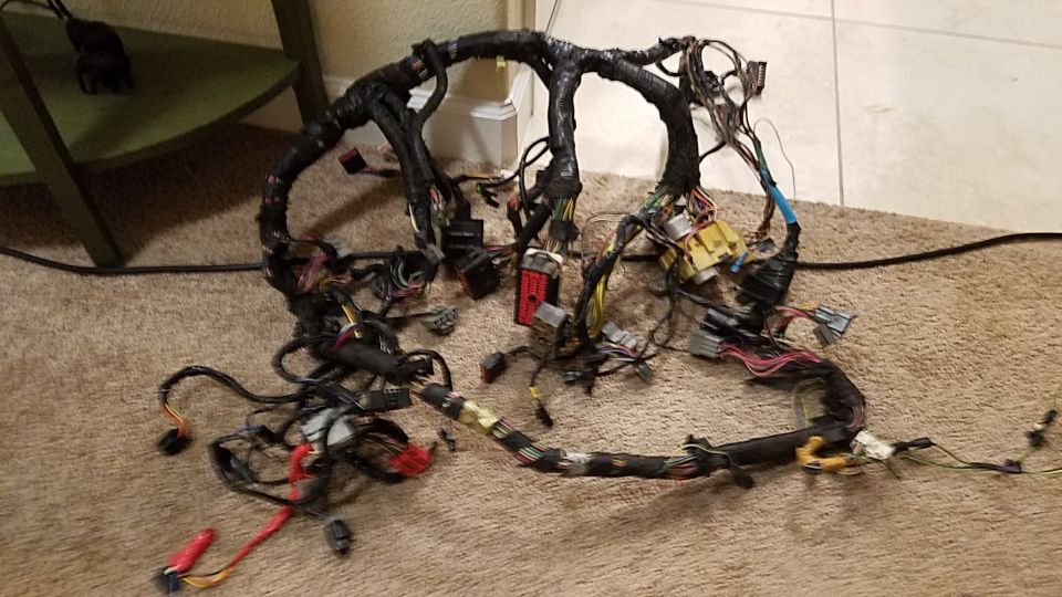 Automotive wiring harness spread out on a carpeted floor