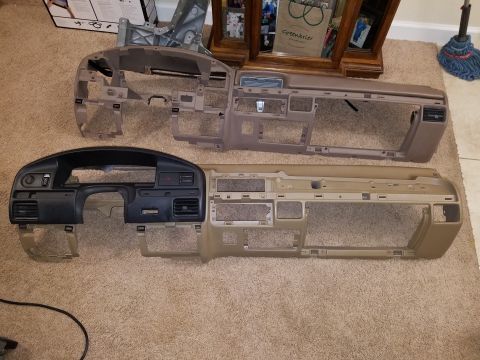 1994 Ford Bronco - Two vehicle dashboards are shown side-by-side on a carpeted floor.