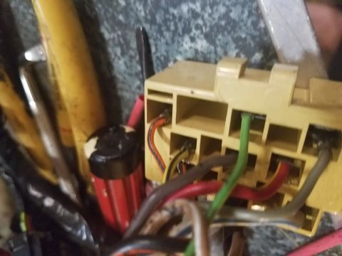 1994 Ford Bronco - Photograph of a tan multi-pin electrical connector with colored harness wires.