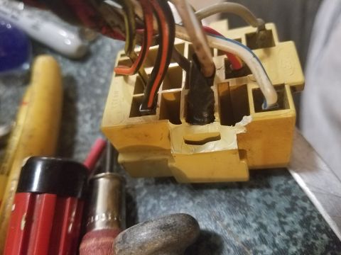 1994 Ford Bronco - Photograph of a yellow multi-pin connector with frayed wires among hand tools.