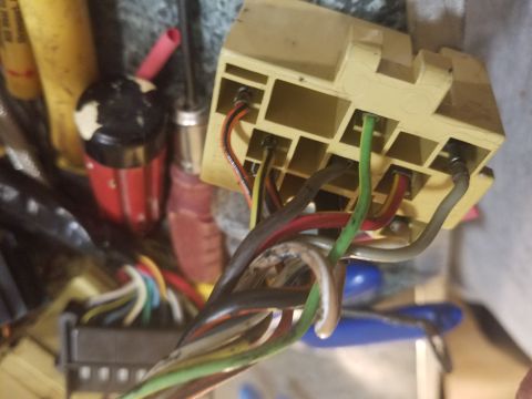 1994 Ford Bronco - Photograph of a tan electrical connector and bundle of colored harness wires.