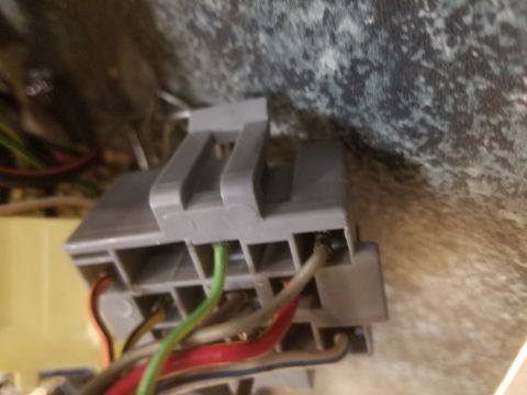 1994 Ford Bronco - Photograph of an automotive gray plastic connector with attached wires, not a technical document.