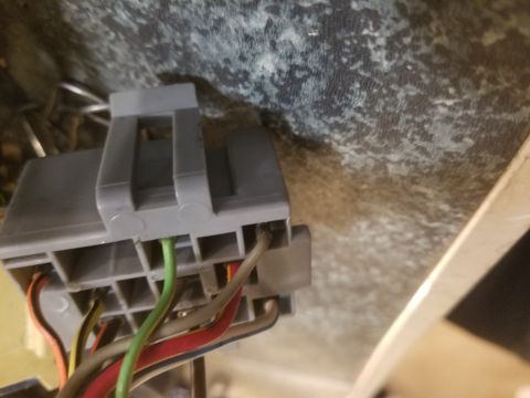 1994 Ford Bronco - Photograph of an automotive gray connector with attached colored wires, not a technical diagram.