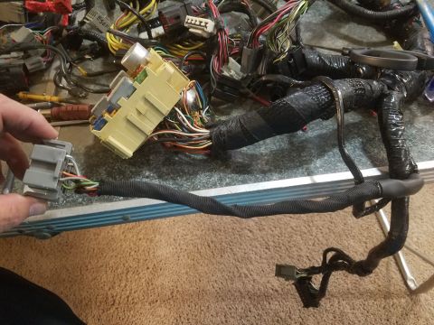1994 Ford Bronco - Photograph of an automotive wiring harness and fuse box assembly spread on a table, not a technical document.