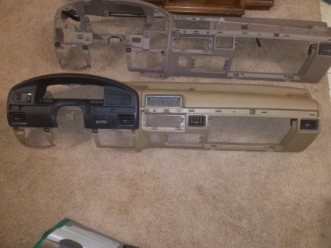 1994 Ford Bronco - Photograph of automotive dashboard panels laid out on carpet, not a technical diagram.
