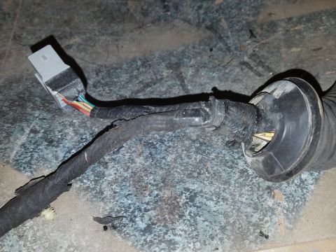 1994 Ford Bronco - Photograph of a vehicle wiring harness with a white multi-pin connector, not a technical document.