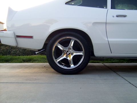 1978 Ford Mustang II - Rear side view of a white 1978 Ford Mustang II coupe with a chrome wheel.