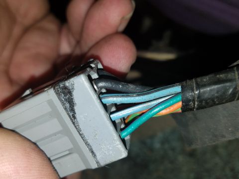 1994 Ford Bronco - Photograph of a hand-held electrical connector with colored wires, not a technical document.