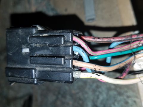 1994 Ford Bronco - Photograph of a black electrical connector with color-coded wires, not a document.
