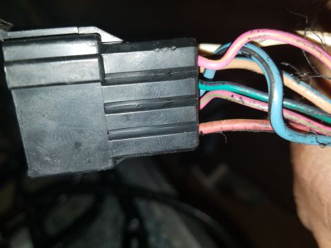1994 Ford Bronco - Photograph of a hand-held black electrical connector and wiring, not a diagram.