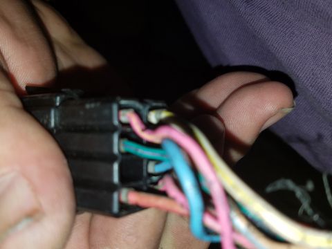 1994 Ford Bronco - Photograph of a hand-held electrical connector with colored wires, not a document.