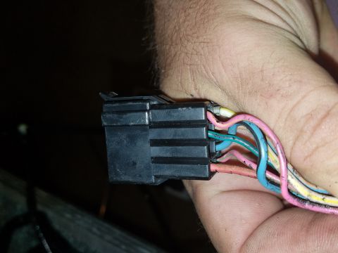 1994 Ford Bronco - Photograph of a hand-held electrical connector with color-coded wires, not a document.