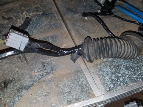 1994 Ford Bronco - Photograph of a wrapped automotive wiring harness with connector, not a diagram.