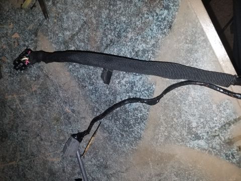 1994 Ford Bronco - Photograph of a sleeved automotive wiring harness with connectors, not a document.