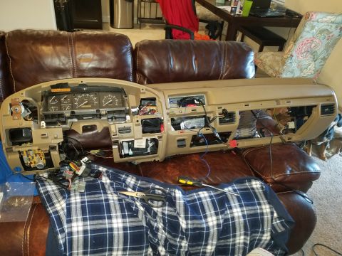 1994 Ford Bronco - Photograph of a disassembled Ford truck dashboard with cluster and vents, not a technical document.