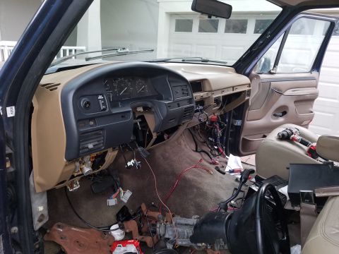 1994 Ford Bronco - Photograph of a truck cab interior during dash reinstallation, not a technical document.
