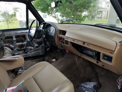1994 Ford Bronco - Photograph of a truck cab interior with dash and insulation during a build, not a technical document.