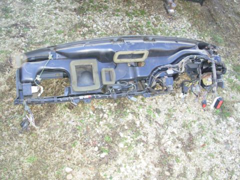 1994 Ford Bronco - Photograph of a removed dashboard frame and harness on the ground, not a technical document.