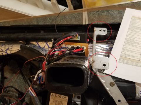 1994 Ford Bronco - Annotated photograph of underdash wiring and brackets with circled details, not a technical document.