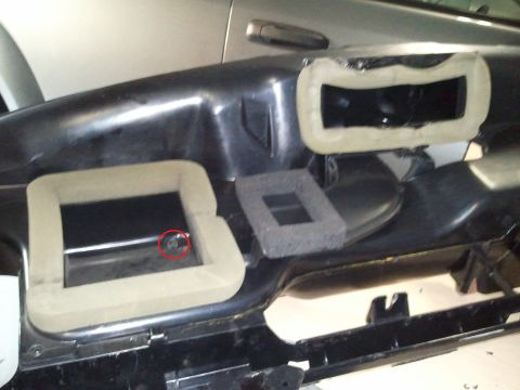 1994 Ford Bronco - Photograph of the dash underside with foam vent seals and a marked fastener, not a technical document.