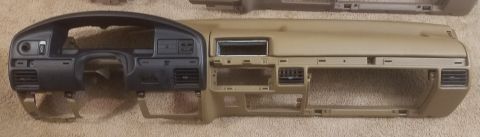 1994 Ford Bronco - Photograph of dashboard shells laid out for comparison, not a technical document.