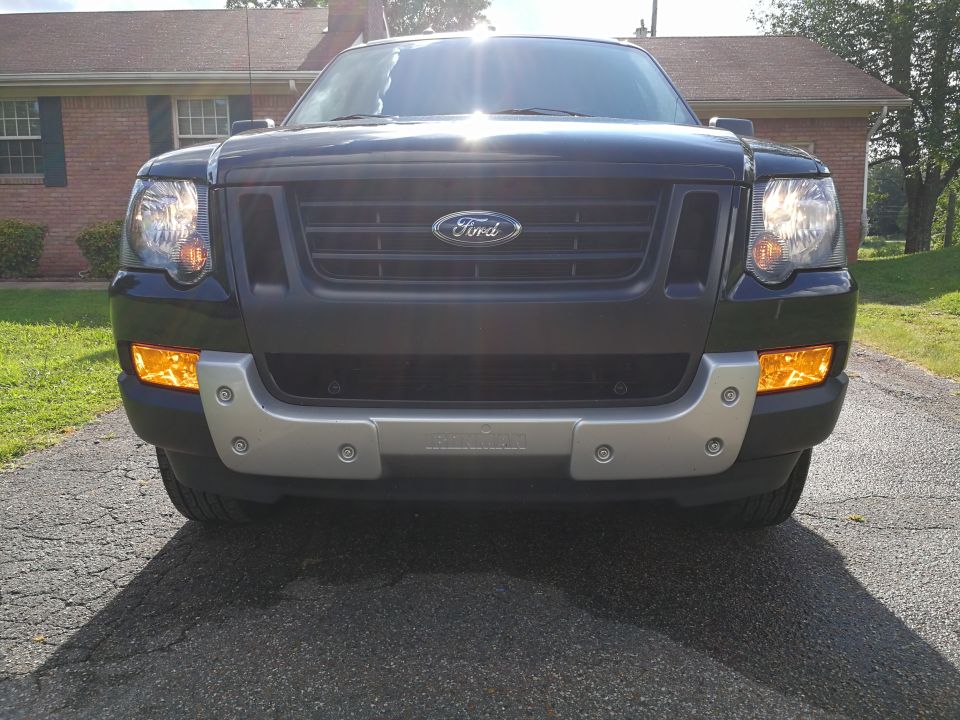 Black Ford Explorer SUV front view with amber fog lights