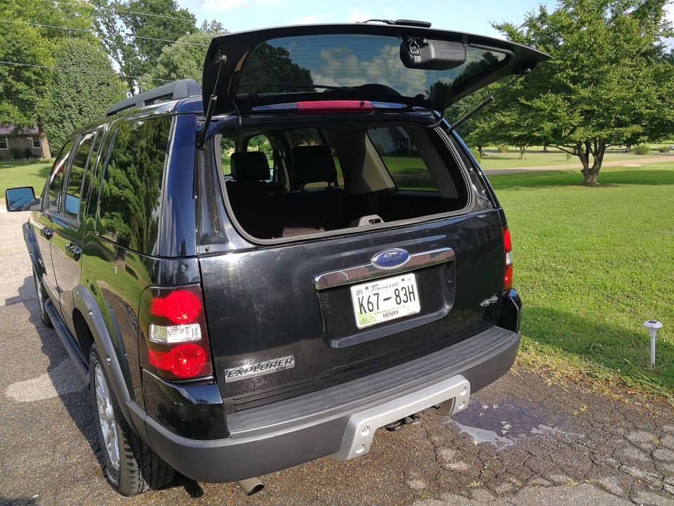 Black 2007 Ford Explorer SUV with liftgate open, rear view, Tennessee license plate K67-83H