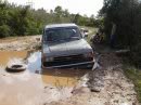 1989 Ford Bronco - This 1989 Ford Bronco is stuck deep in the mud on an unpaved road.