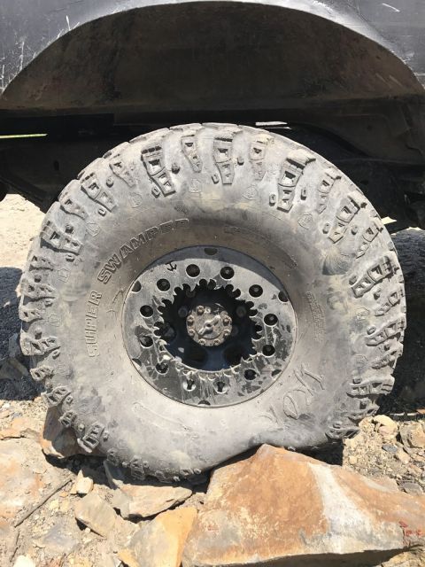 1989 Ford Bronco - This image focuses on a off-road tire and wheel assembly, likely modified for extreme terrain.