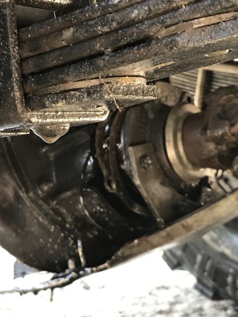1989 Ford Bronco - A close-up view of a vehicle's suspension system, focusing on the leaf spring and axle components.