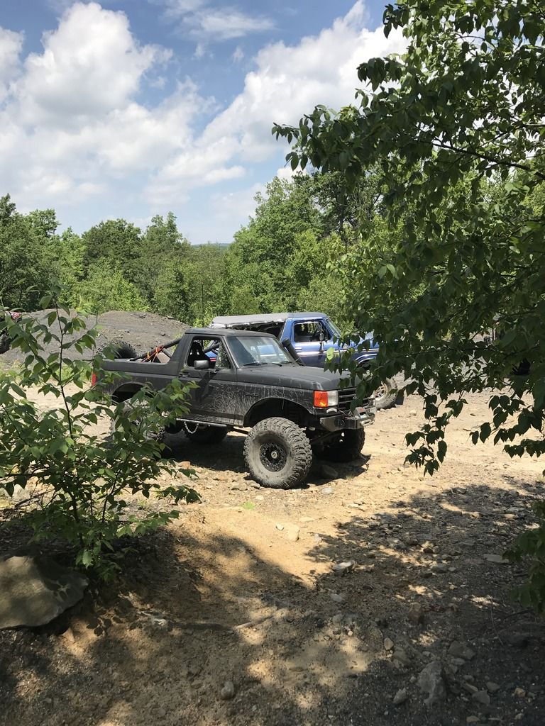 Black off-road SUV with large tires, seen from a 3/4 front angle