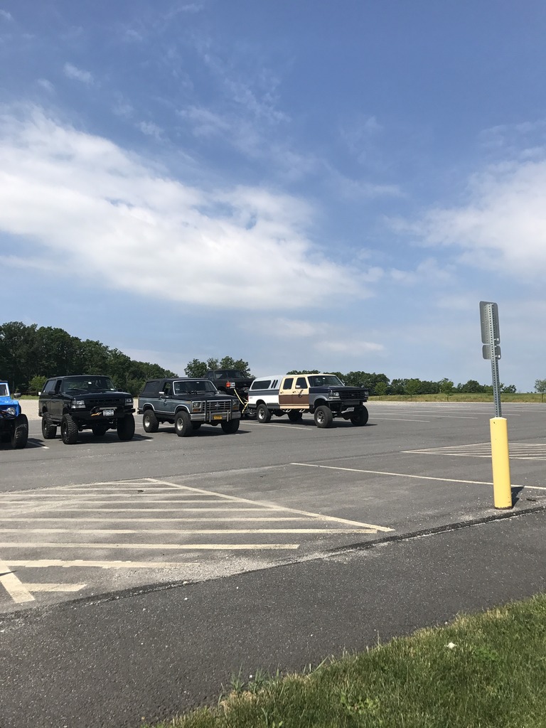 Gray 1987 Ford Bronco parked in a lot with other trucks and SUVs