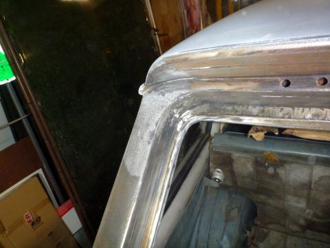 1962 MG B - Metalwork and primer visible on the A-pillar and roof seam of a vehicle undergoing repair.