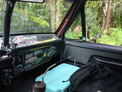 1989 Ford Bronco - Interior view of a 1989 Ford Bronco, dashboard adorned with numerous stickers.