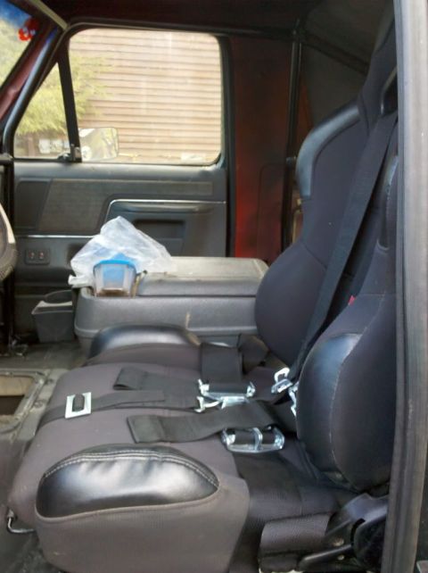 1989 Ford Bronco - Custom racing seats and center console installed in a vehicle's interior.