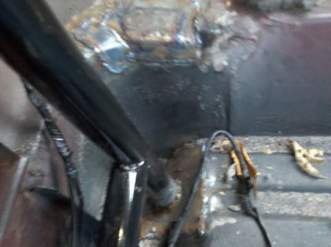 1989 Ford Bronco - The interior floor of a vehicle shows signs of rust and recent welding work.